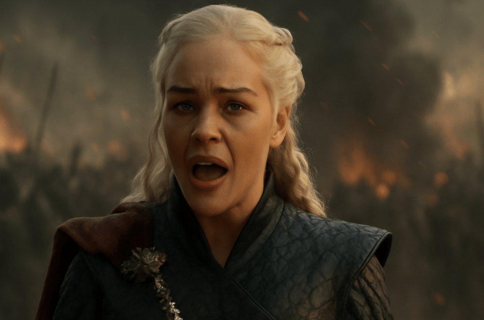 A dramatic fantasy scene featuring a woman with long blonde hair in a dark, textured outfit with a decorative brooch, shouting passionately with a fiery battlefield and smoke in the background. 