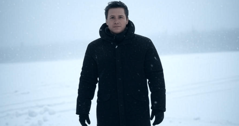 Confident person standing in an intense snowstorm, wearing a thick winter coat and facing the wind, symbolizing resilience and strength to overcome life’s challenges, with a focused and prepared demeanor.