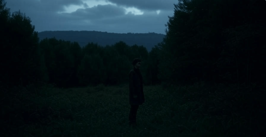 Lone figure standing in a dark, expansive environment with looming shadows, evoking isolation and fear of the unknown, perfect for horror themes