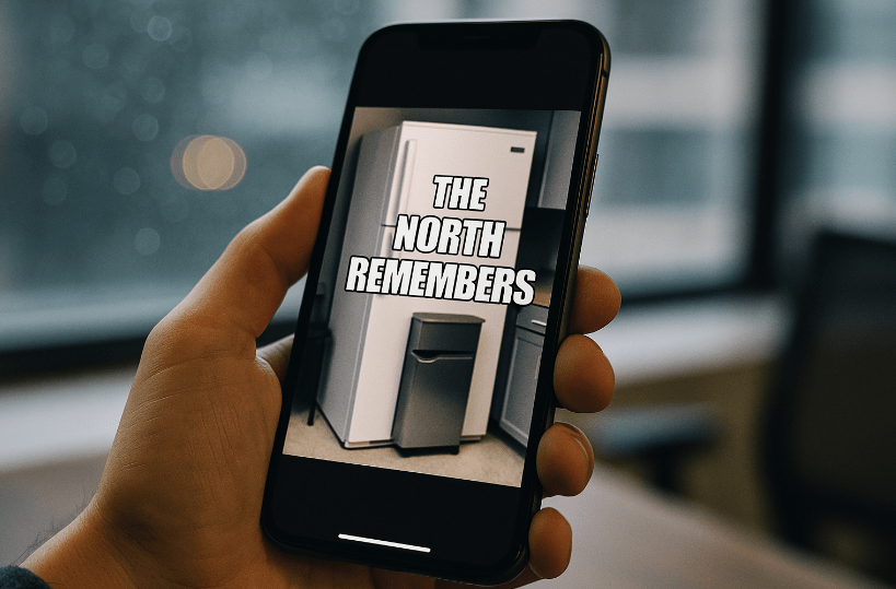 Close-up of a smartphone showing a humorous ‘The North remembers’ meme over an office fridge, symbolizing loyalty and playful modern commentary.