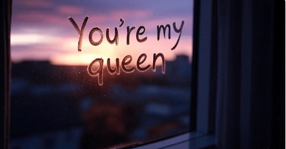 Reflective symbolic image of the quote 'You’re my queen' written in fog on a window, with a blurry sunset in the background, featuring soft focus, a melancholic tone, and an emotional, contemplative mood